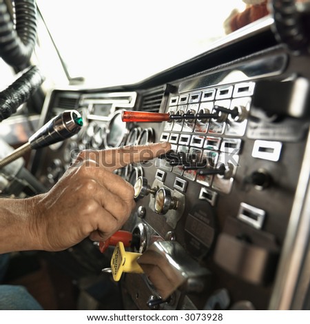 http://image.shutterstock.com/display_pic_with_logo/85699/85699,1176450315,1/stock-photo-interior-of-mid-adult-caucasian-male-hand-pressing-switch-on-dashboard-of-a-tractor-trailer-3073928.jpg