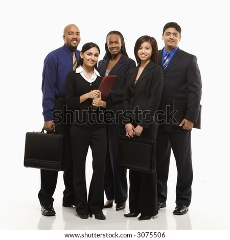 Multi-ethnic business group of men and women standing with briefcases looking at viewer.