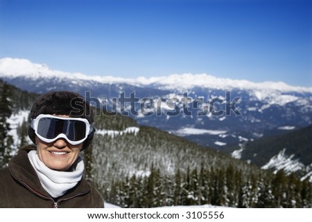 Caucasian middle-aged woman skier posing on mountain Whistler, British Columbia, Canada.