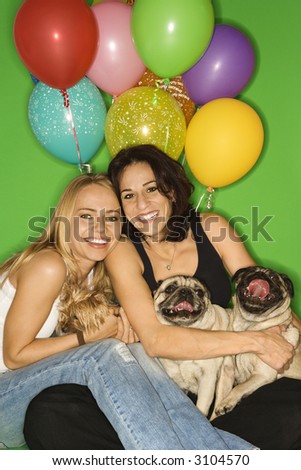 Caucasian prime adult and young adult females with small dogs and festive balloons.