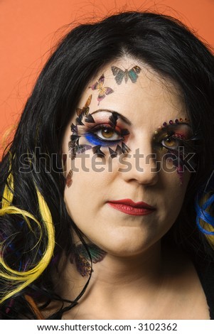 Head shot portrait of Caucasian woman with unique makeup and hair.