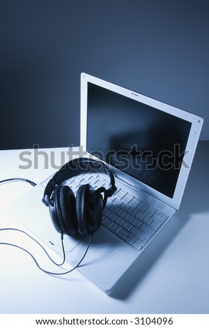Headphones placed on laptop computer.