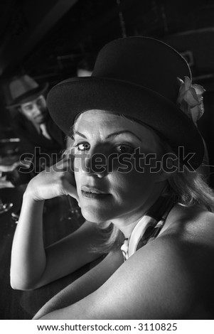 Caucasian prime adult retro female sitting at bar looking at viewer.