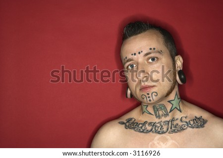 stock photo : Caucasian mid-adult man with tattoos and piercings.