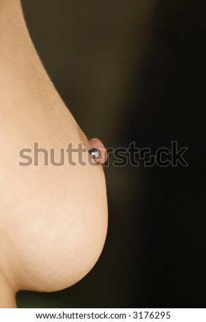 stock photo : Close up of Caucasian female young adult breast with pierced 