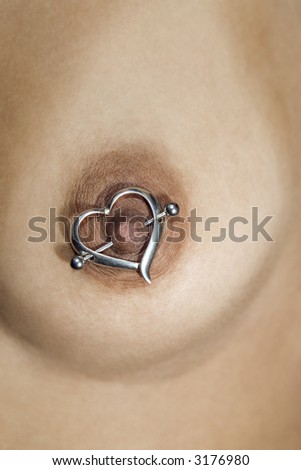  Multi ethnic young adult female breast with heart shaped nipple ring
