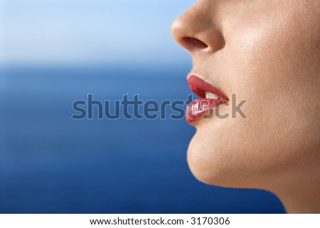 Close up portrait of woman\'s face with Pacific Ocean in background in Maui, Hawaii, USA.