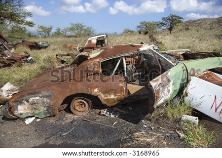 stock photo Old rusted car in junkyard