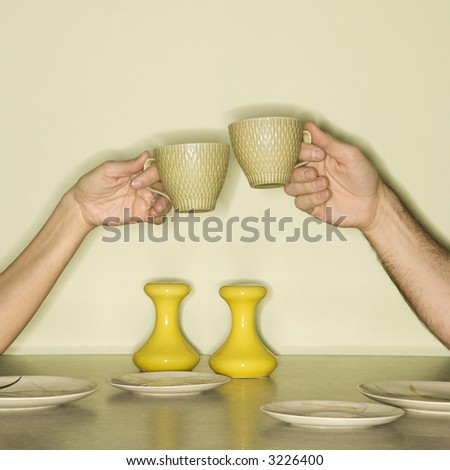 白种人中间成人男和女性手敬酒与咖啡杯横跨r