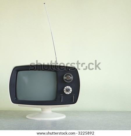 Still life of vintage television set with antenna raised.