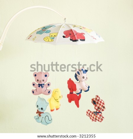 Still life of vintage baby mobile with colorful moving animals.