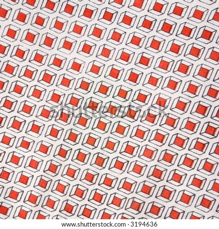 Close-up of vintage fabric with repetitive red cube designs printed on polyester.