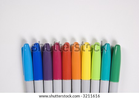 Group of colorful markers lined up in a row.