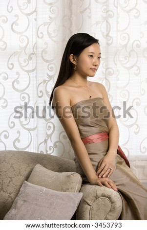 Portrait of an Asian woman in a bridesmaid dress.