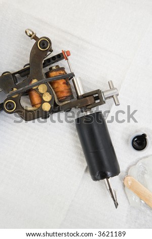 Close up shot of tattoo gun and black ink.