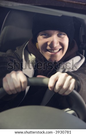 Caucasian male teenager behind the steering wheel.