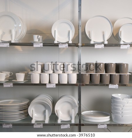 Retail display of porcelain dishes and mugs.