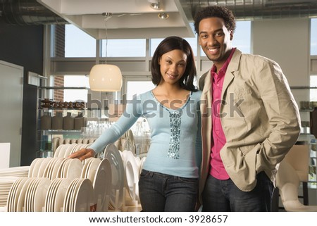 Portrait of African American couple in home furnishings retail store.