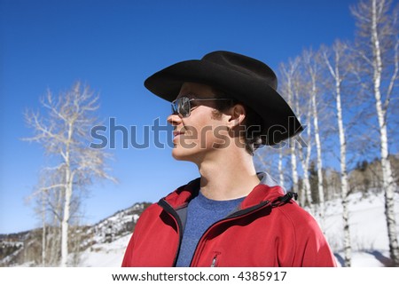 Mid-adult Caucasian male cowboy wearing sunglasses cowboy hat.