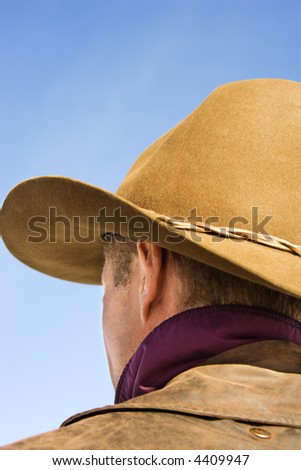 Back of a Middle-aged Caucasian male wearing a cowboy hat.