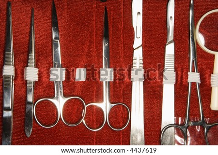 Medical kit with tweezers, scissors, scalpel.