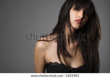 Head and shoulder portrait of pretty young woman with long black hair.