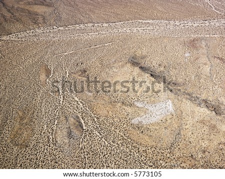 Aerial view of torrid California desert with rocky landforms.