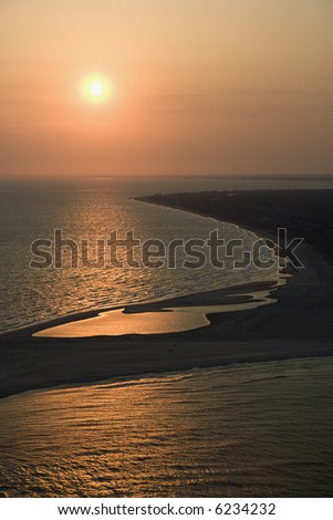 Aerial view of sun over Atlantic ocean and shoreline of Bald Head Island, North Carolina.