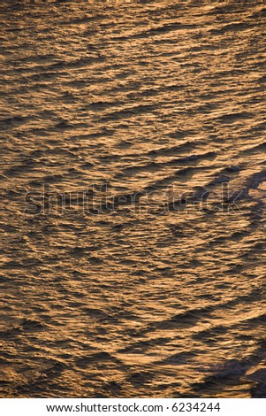 Aerial of rippled Atlantic ocean water with sun reflection.