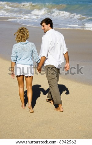 couple holding hands on beach. couple holding hands