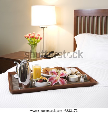 stock photo : Breakfast tray laying on white bed in upscale hotel. stock photo : Breakfast tray laying on white bed in upscale hotel.