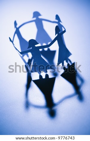 People Holding Hands Paper Cut Out. stock photo : Cutout paper