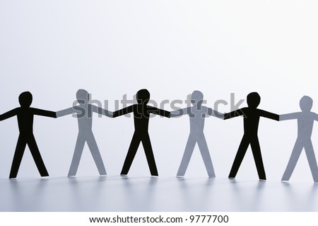 stock photo : Black and white paper cutout men standing holding hands 