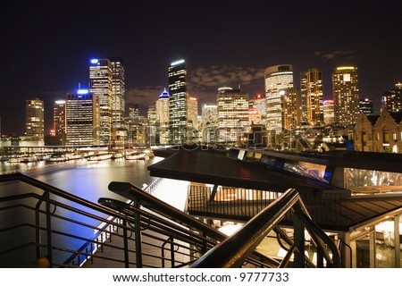 Night cityscape with buildings and harbor in Sydney, Australia.