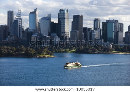 Aerial view ferryboat crossing harbour with skyline of Sydney, Australia.