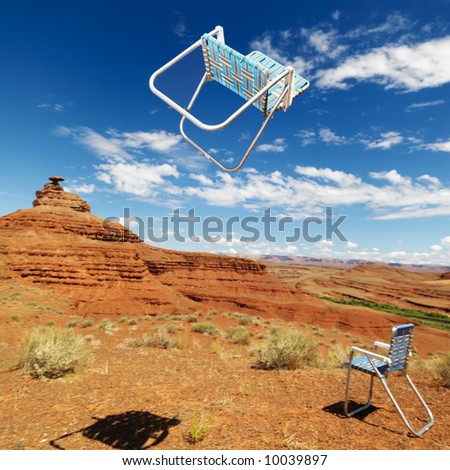 Lawn chair thrown in midair in scenic desert landscape with land formation.