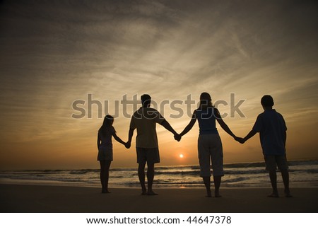people holding hands in the sunset. of family holding hands on