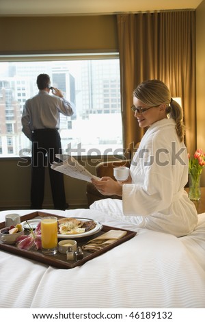 http://image.shutterstock.com/display_pic_with_logo/85699/85699,1264723598,2/stock-photo-caucasian-woman-in-a-robe-sits-on-a-hotel-bed-while-reading-the-newspaper-a-man-stands-in-the-46189132.jpg