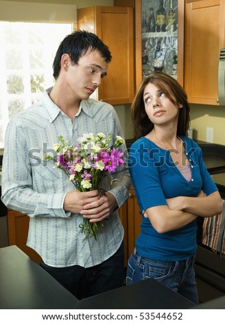 Husband trying to give wife flowers and getting the cold shoulder.