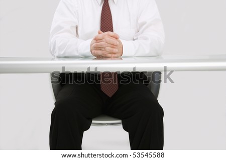 Detail of Caucasian middle aged businessman sitting at desk.