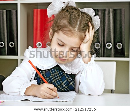 girl in school uniform doing school work