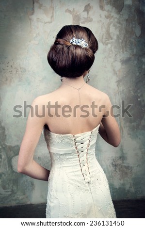 beautiful girl in the dress of the bride from the back