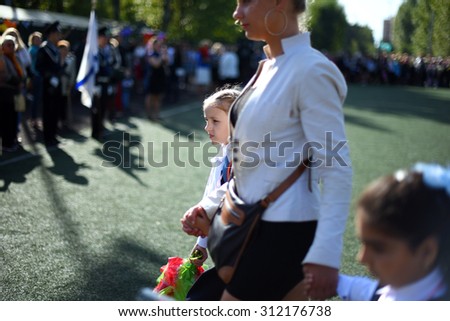 Saint Petersburg, Russia - September 1, 2015: Children go to school. On the Day of knowledge in Russia, the first day of school. Children lead by the hand to school.