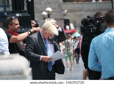 LONDON, UK - JULY 17TH 2013: London mayor Boris Johnson preparing to give an interview outside the City Hall in London, UK, on July 17th, 2013.