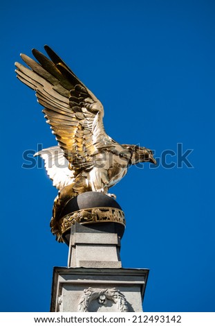 LONDON, UK - MAY 25, 2014: Golden Eagle, part of the Royal Air Force Memorial, spreading his wings over the Victoria Embankment in central London.