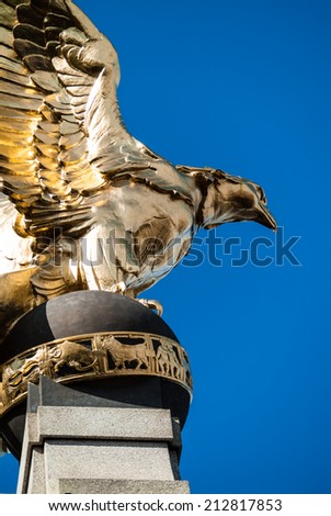 LONDON, UK - MAY 25, 2014: Golden Eagle, part of the Royal Air Force Memorial, spreading his wings over the Victoria Embankment in central London.