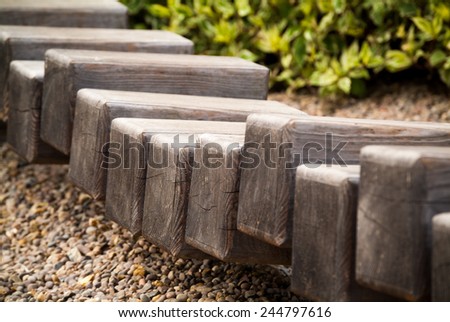 a row of wooden blocks forming a little path in a local park