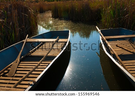 Boats are aligned on the shores of a lake