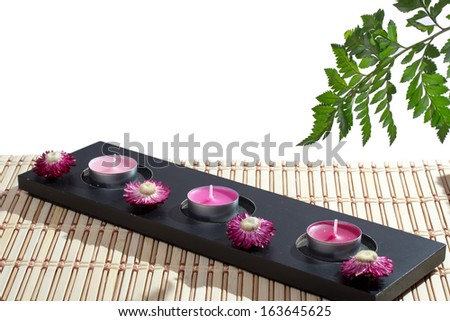 Spa. Green leaf with flower and candles