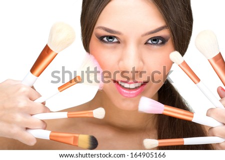 Beautiful model with perfect skin and makeup brushes